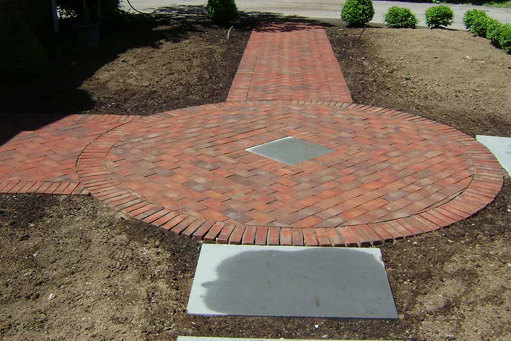 brick pavers arranged in a circle in a yard