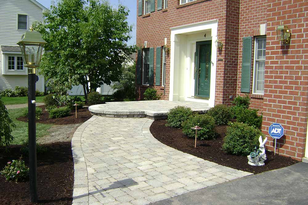 brick house with stone walkway and porch