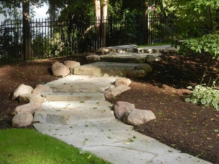 rustic stone steps on pathway in landscape