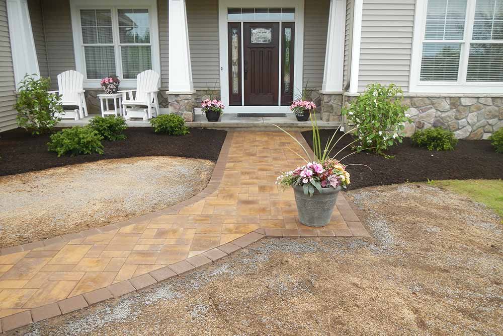 front stone walkway with potted flowers